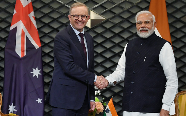 Australian Prime Minister Anthony Albanese and Indian Prime Minister Narendra Modi shake hands.